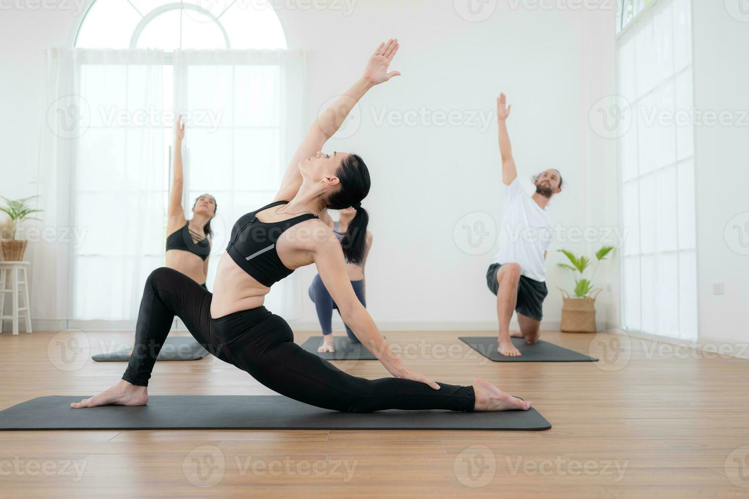 Group of people practicing yoga in a studio. Yoga class concept. photo