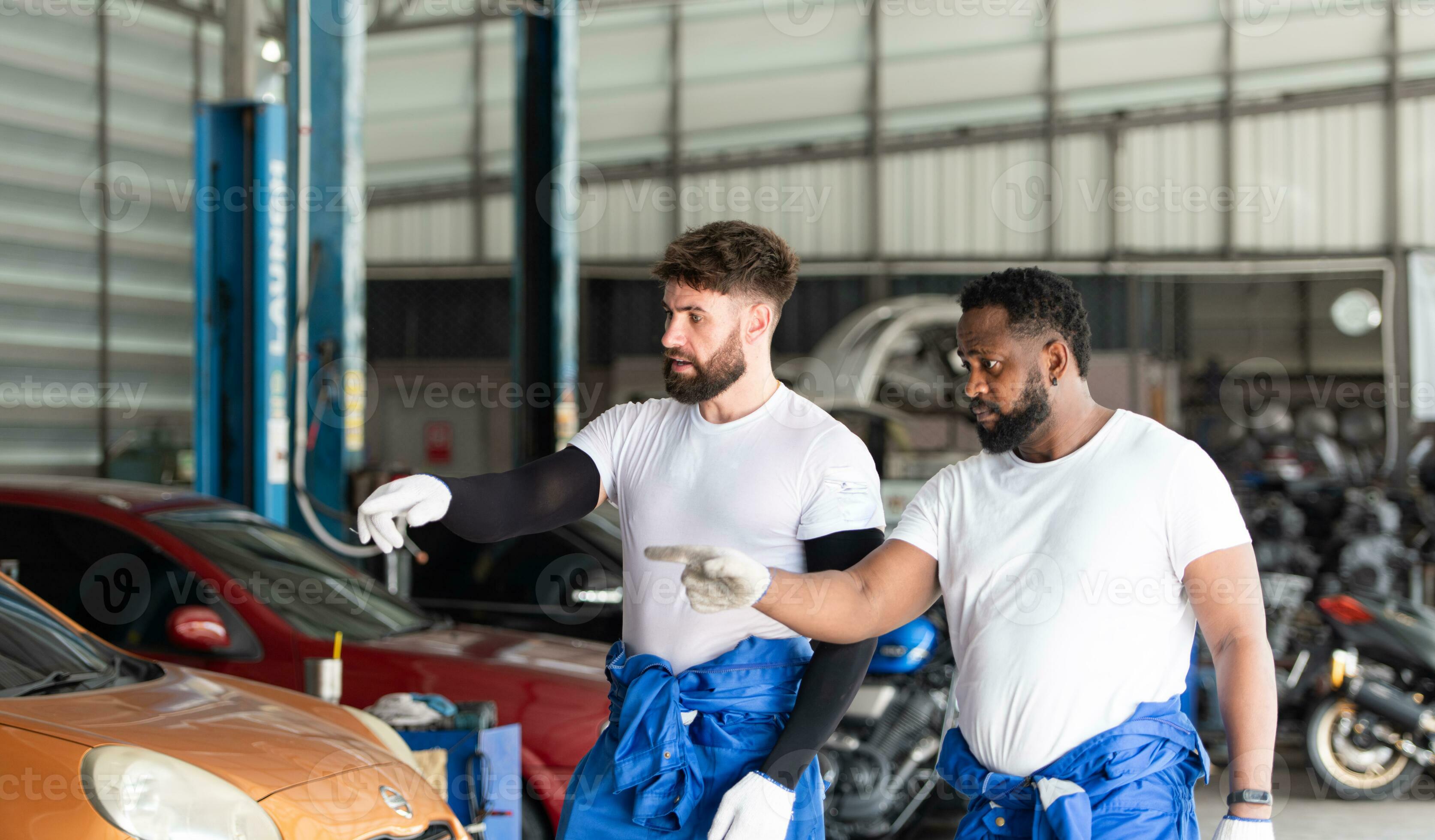 Car mechanic working in an auto repair shop, inspecting the operation