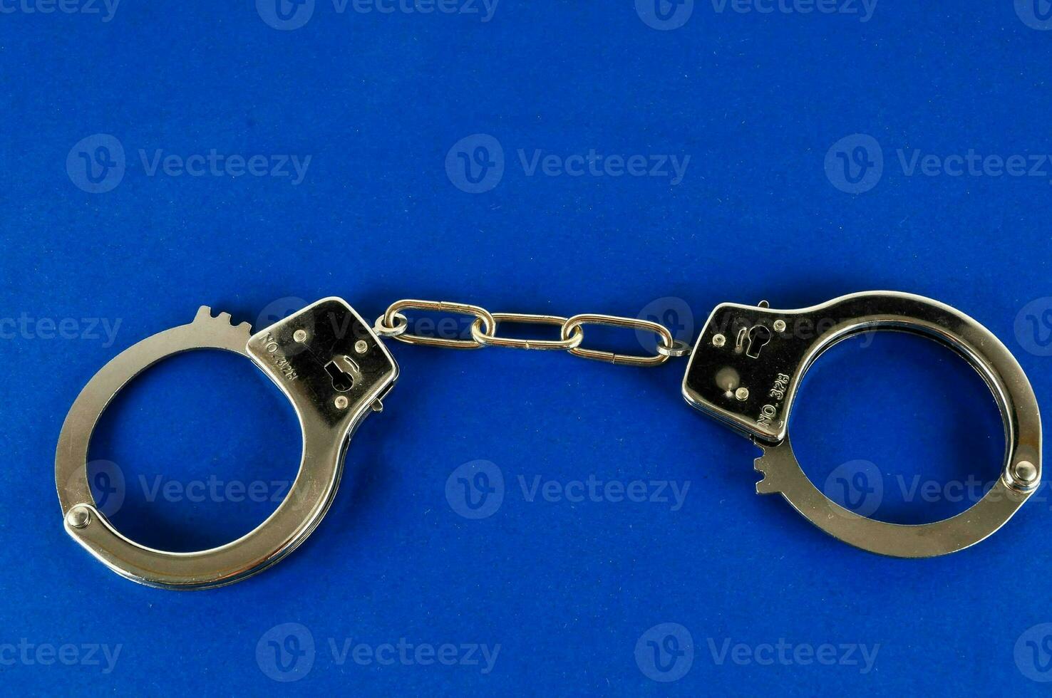 handcuffs on a blue background photo