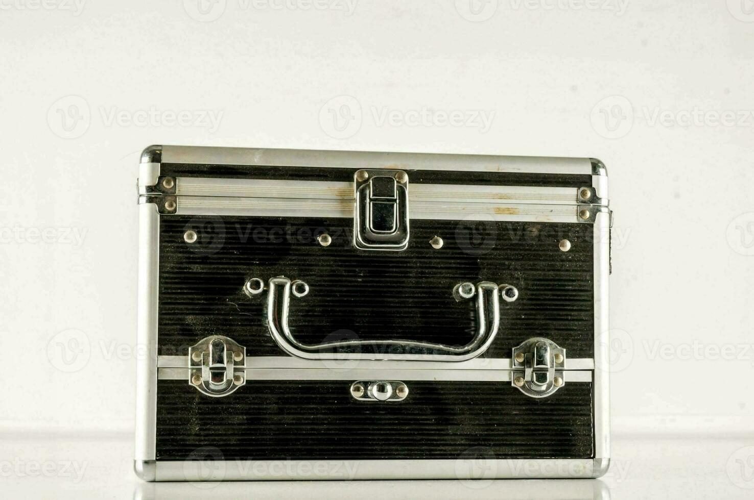 a black and silver suitcase on a white surface photo