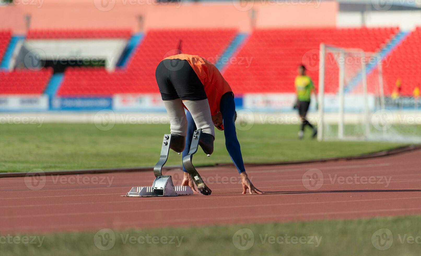 Disabled athletes prepare in starting position ready to run on stadium track photo