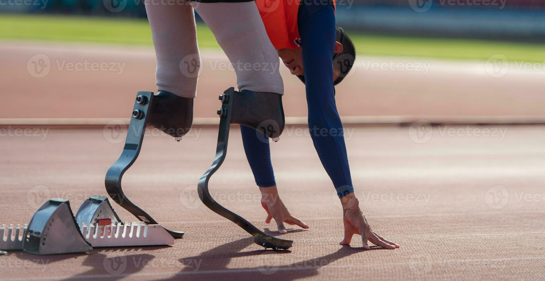 Disabled athletes with running blade used for short races on a running track. photo