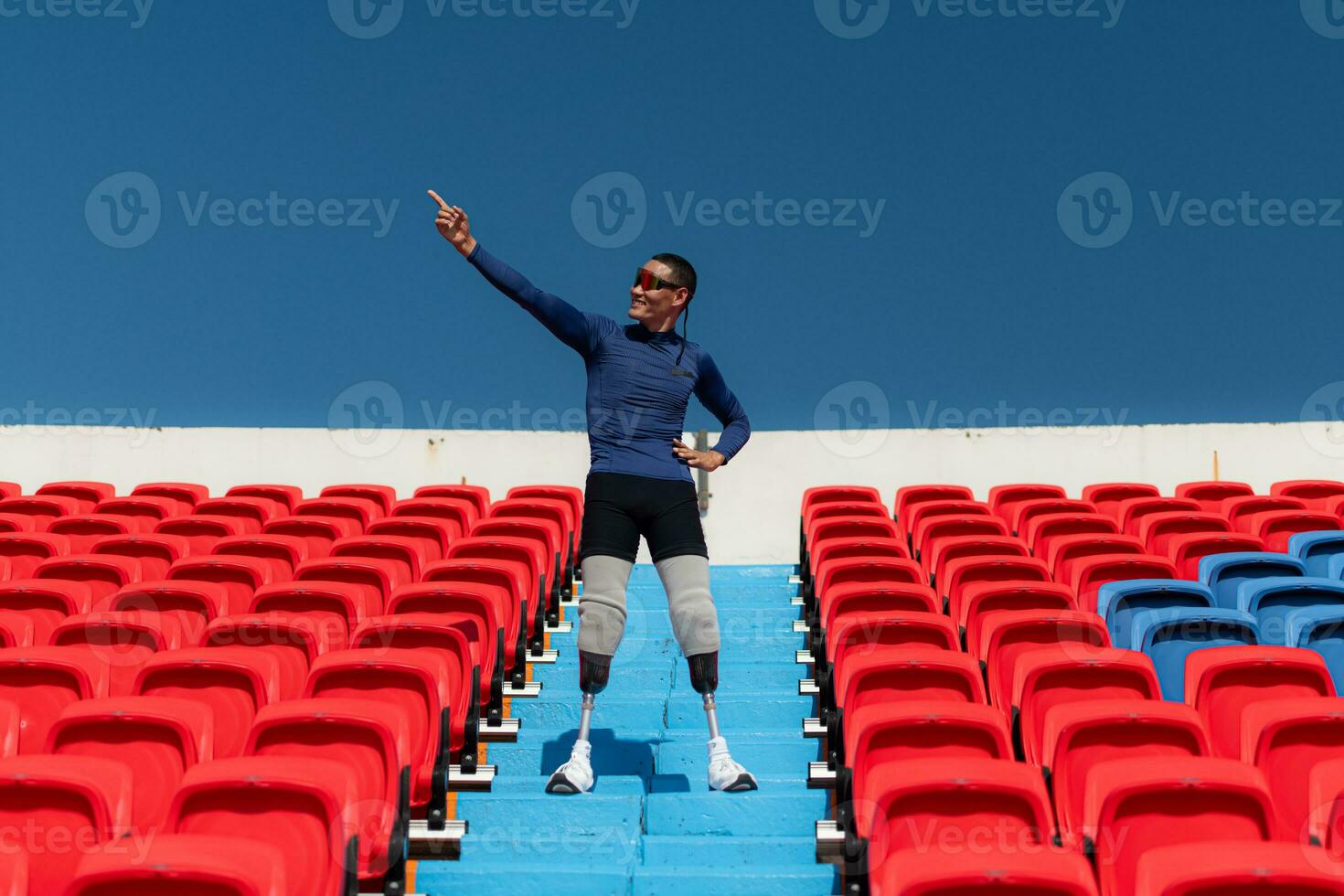 Athletes with disabilities cheer from the stands in a sports arena. photo