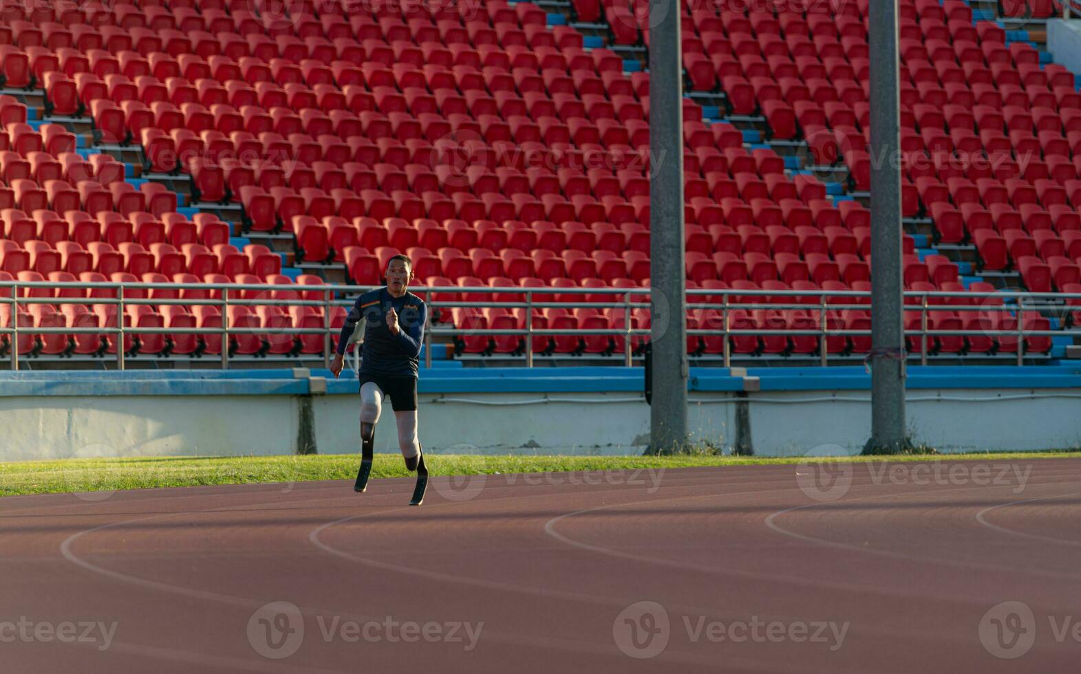 Athletes with disabilities who utilize running blades for short distances. Run down the running track. photo