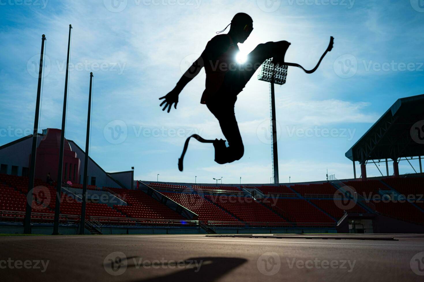 Athletes with disabilities who utilize running blades for short distances. Run down the running track. photo