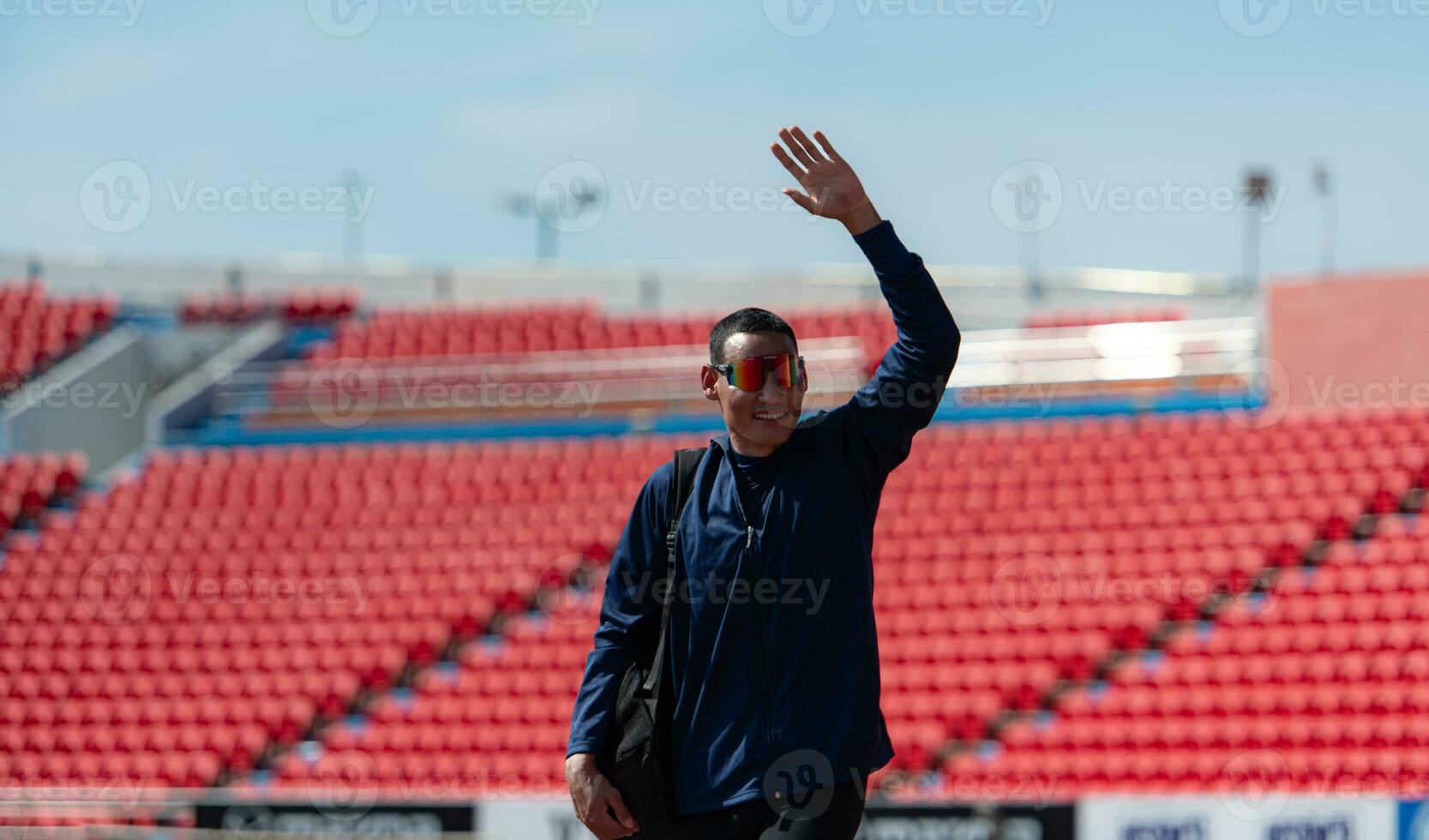 Disabled athletes prepare their bodies on amphitheater in a sports arena on a sunny day before entering a short-distance running competition photo