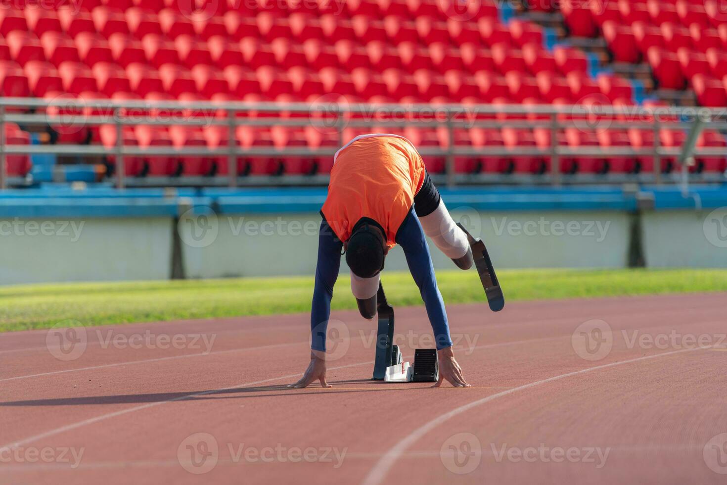 Disabled athletes prepare in starting position ready to run on stadium track photo