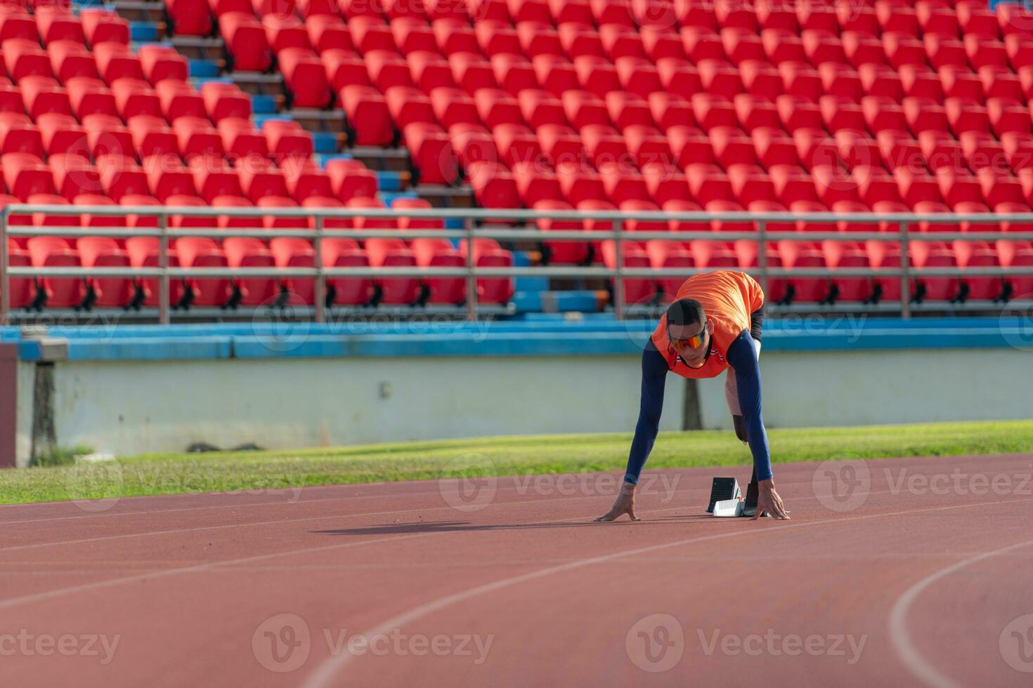 Disabled athletes prepare in starting position ready to run on stadium track photo