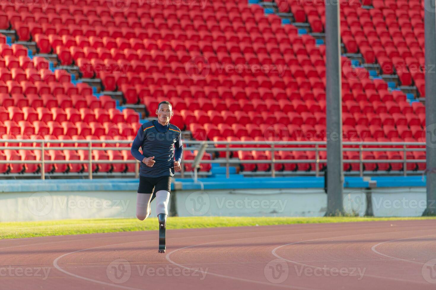 Athletes with disabilities who utilize running blades for short distances. Run down the running track. photo