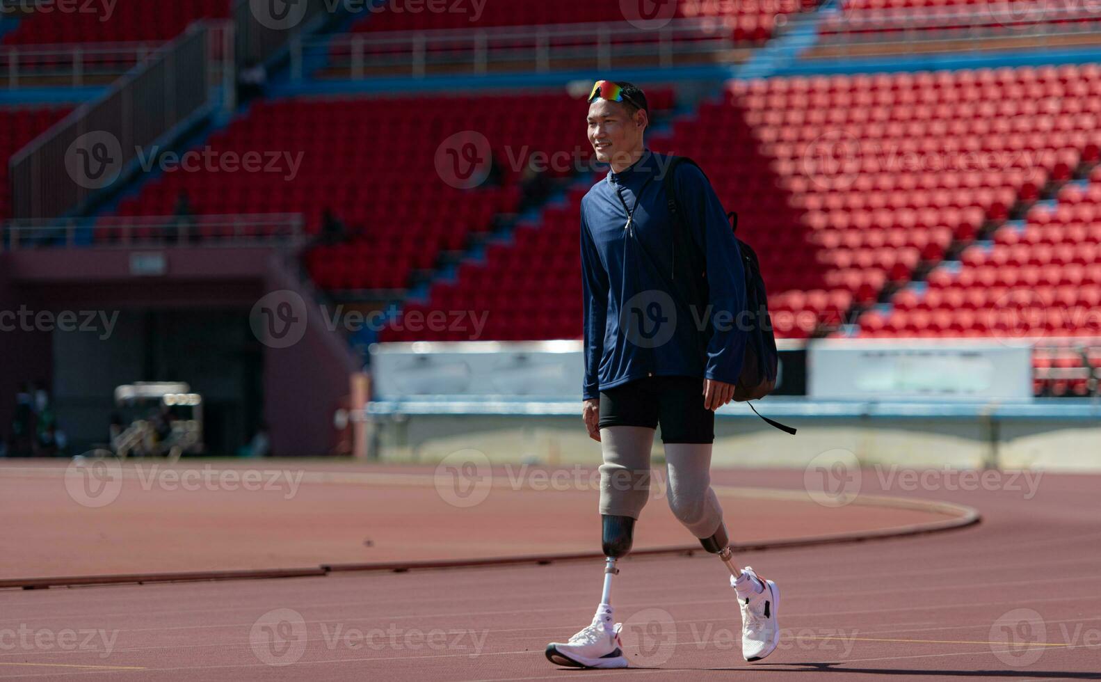 Disabled athletes prepare their bodies on amphitheater in a sports arena on a sunny day before entering a short-distance running competition photo