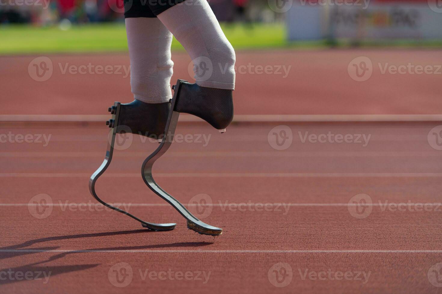 Disabled athletes with running blade used for short races on a running track. photo