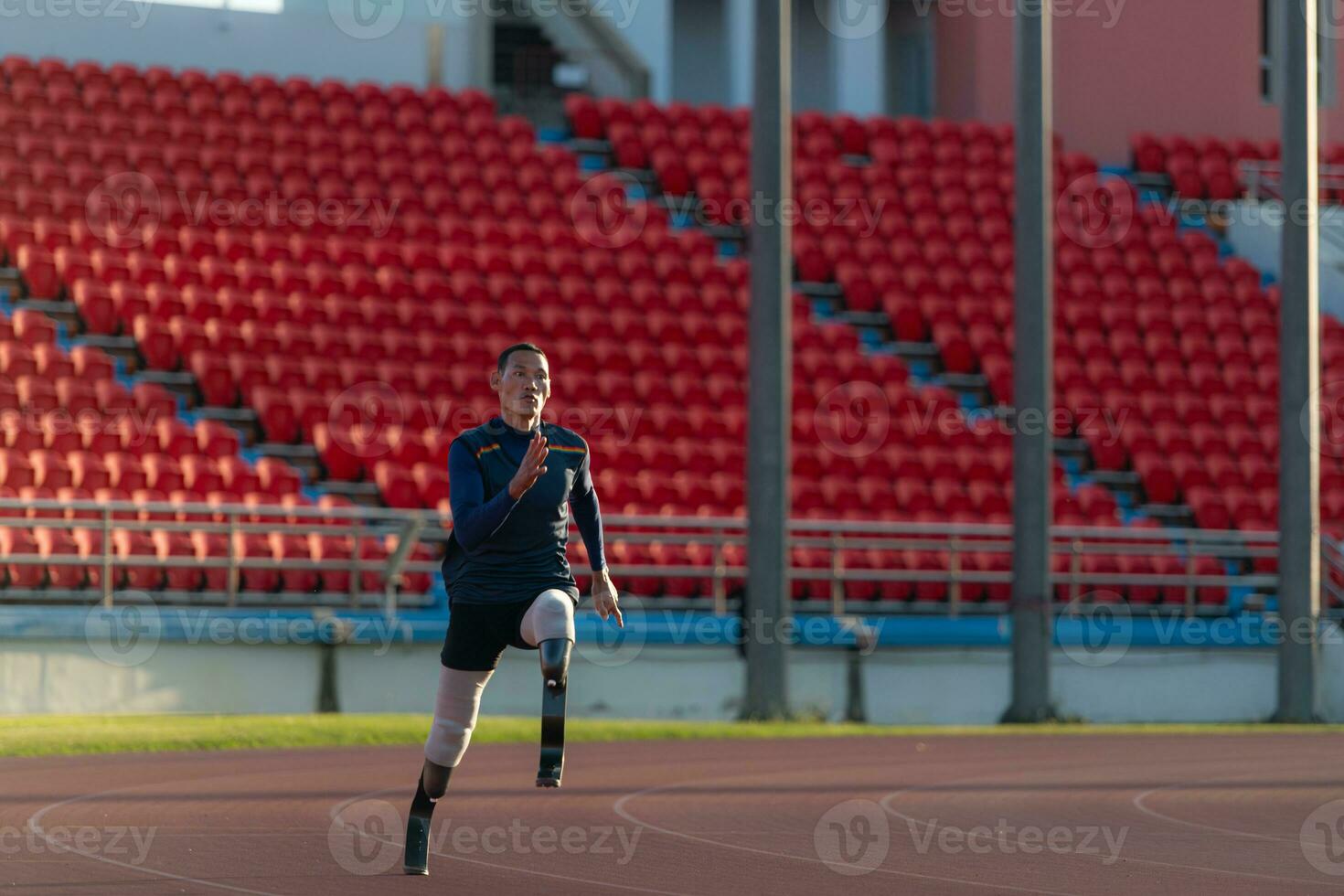 Athletes with disabilities who utilize running blades for short distances. Run down the running track. photo