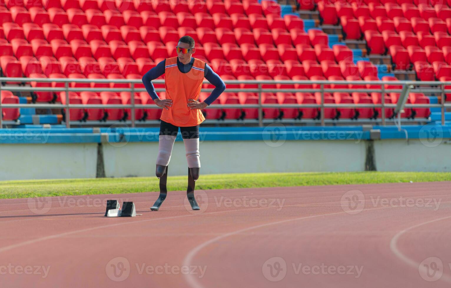 Disabled athletes prepare in starting position ready to run on stadium track photo