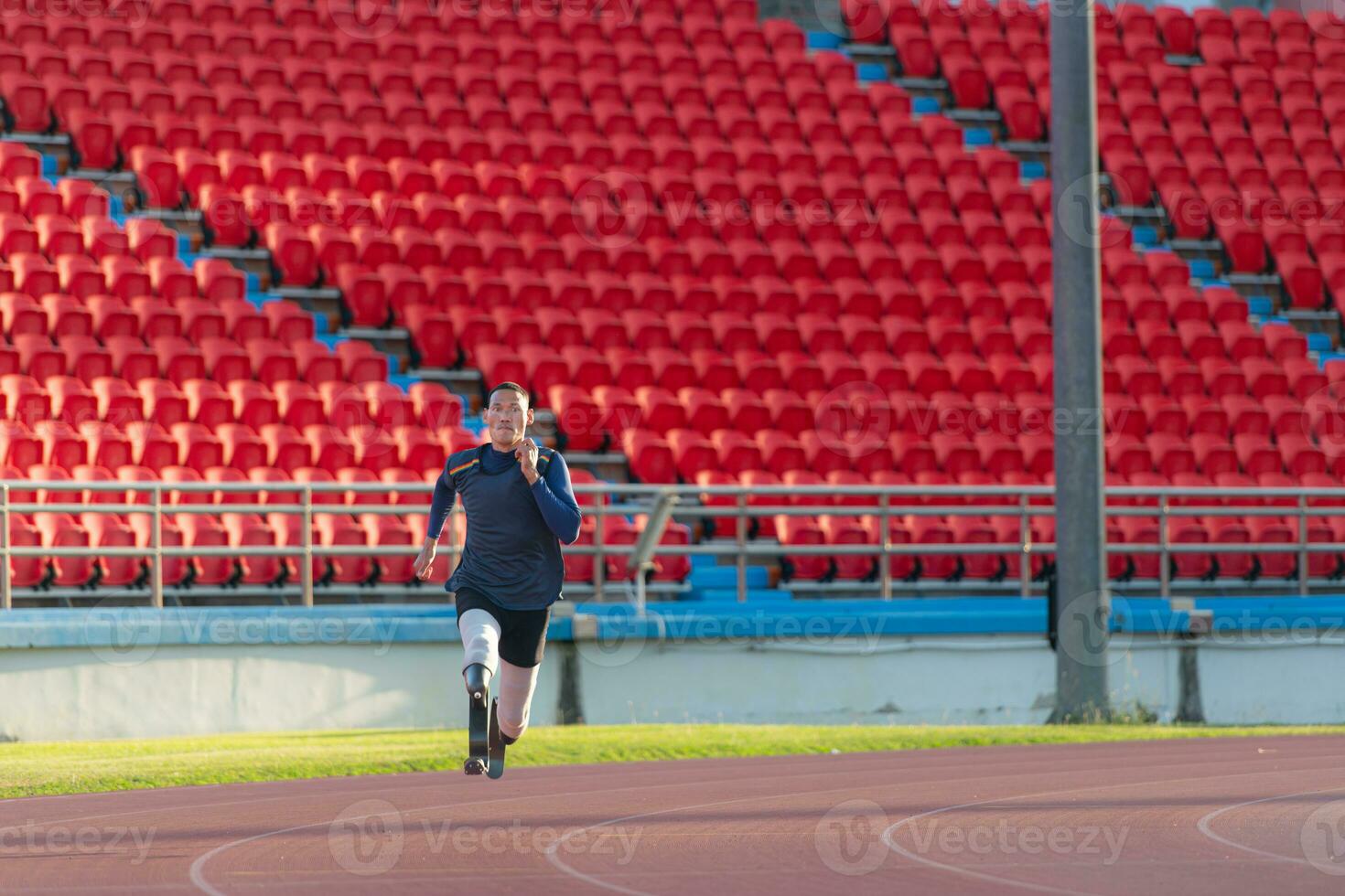 Athletes with disabilities who utilize running blades for short distances. Run down the running track. photo