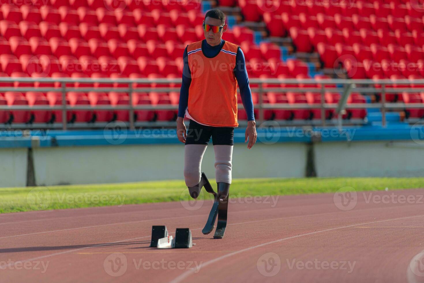 Disabled athletes prepare in starting position ready to run on stadium track photo
