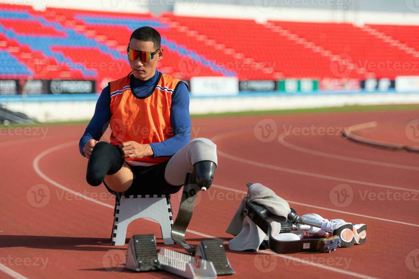 Disabled athletes prepare in starting position ready to run on stadium track photo