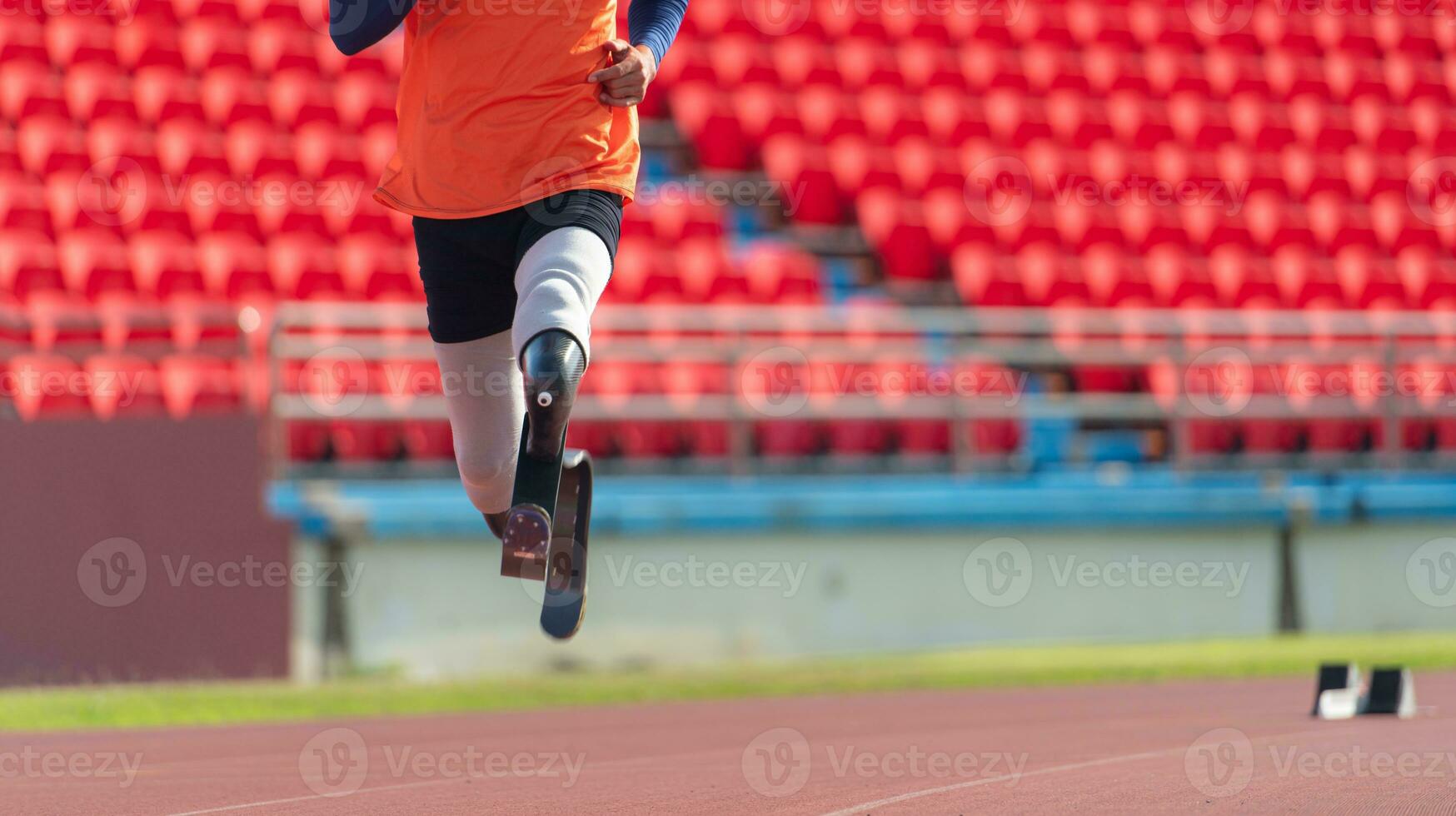 Athletes with disabilities who utilize running blades for short distances. Run down the running track. photo