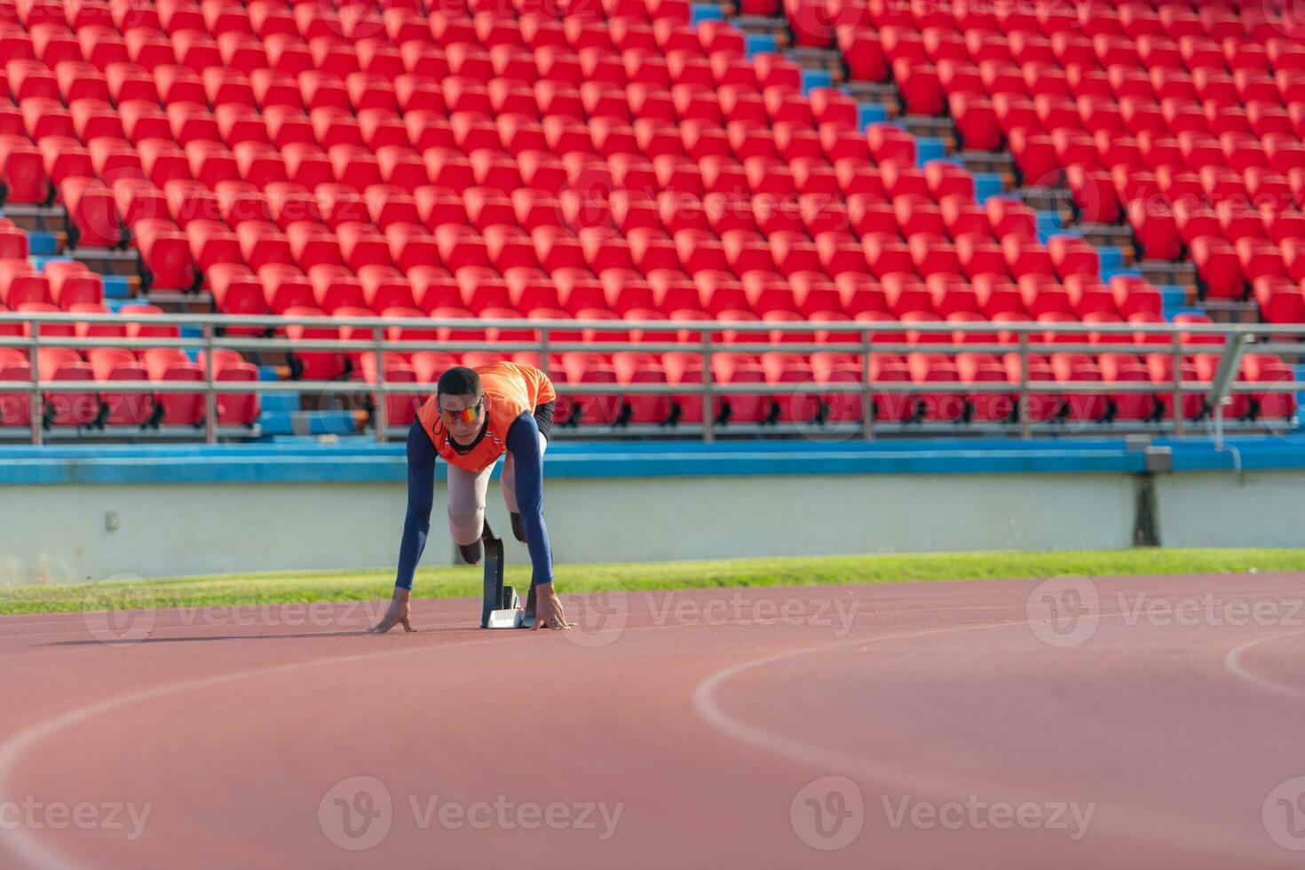 Disabled athletes prepare in starting position ready to run on stadium track photo