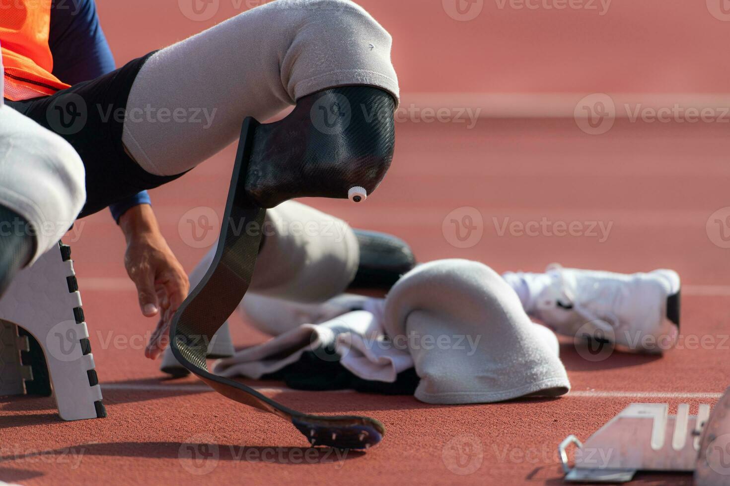 Disabled athletes prepare in starting position ready to run on stadium track photo