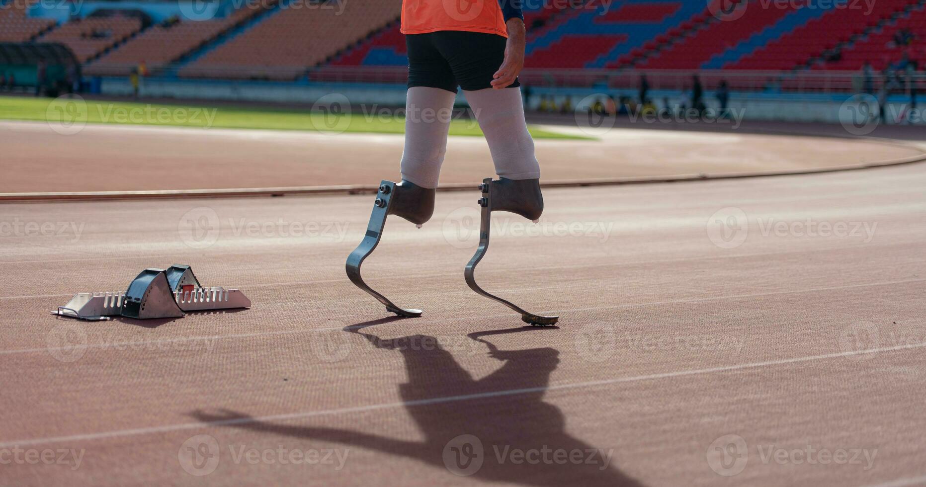 Disabled athletes with running blade used for short races on a running track. photo