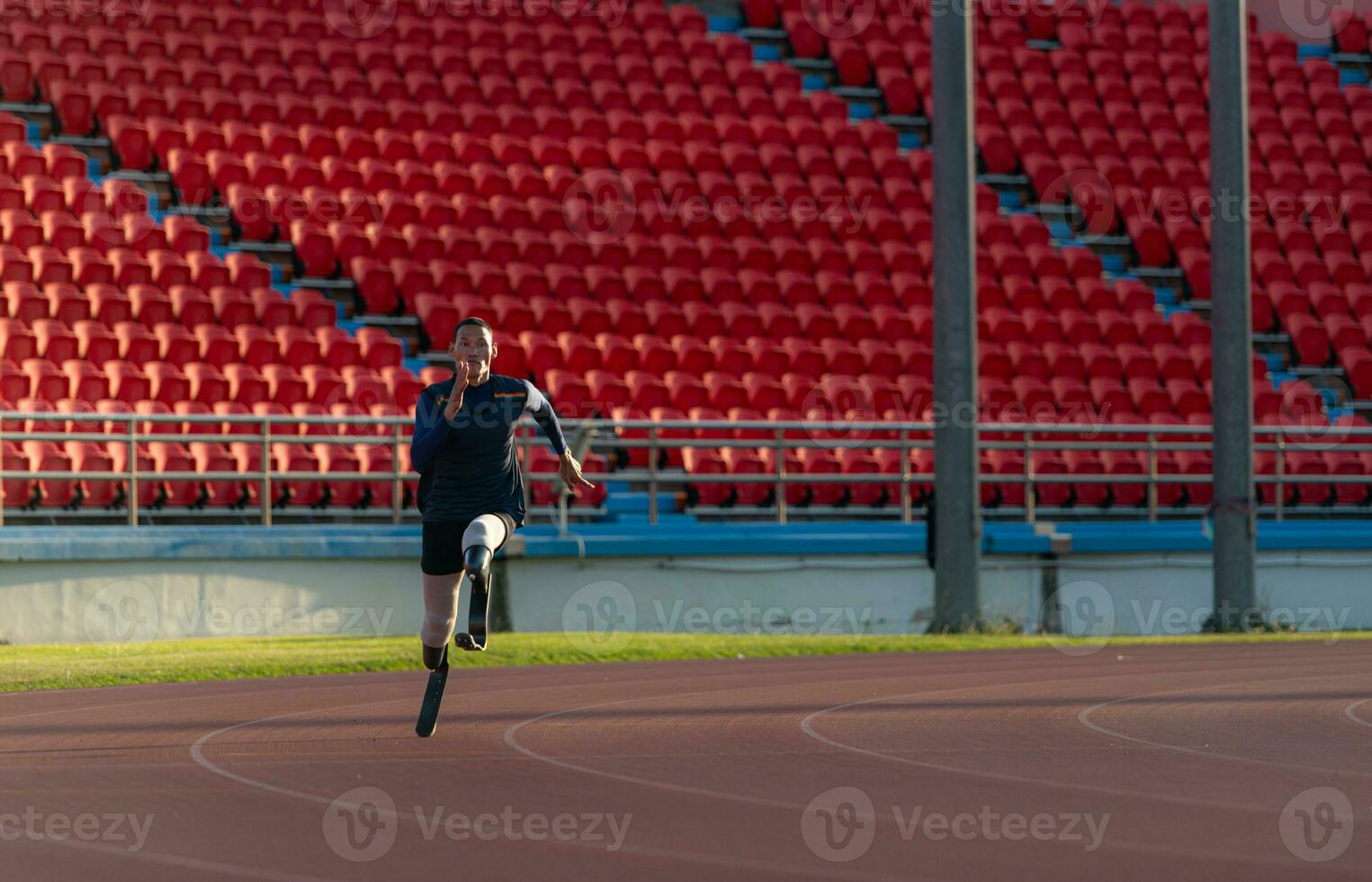 Athletes with disabilities who utilize running blades for short distances. Run down the running track. photo