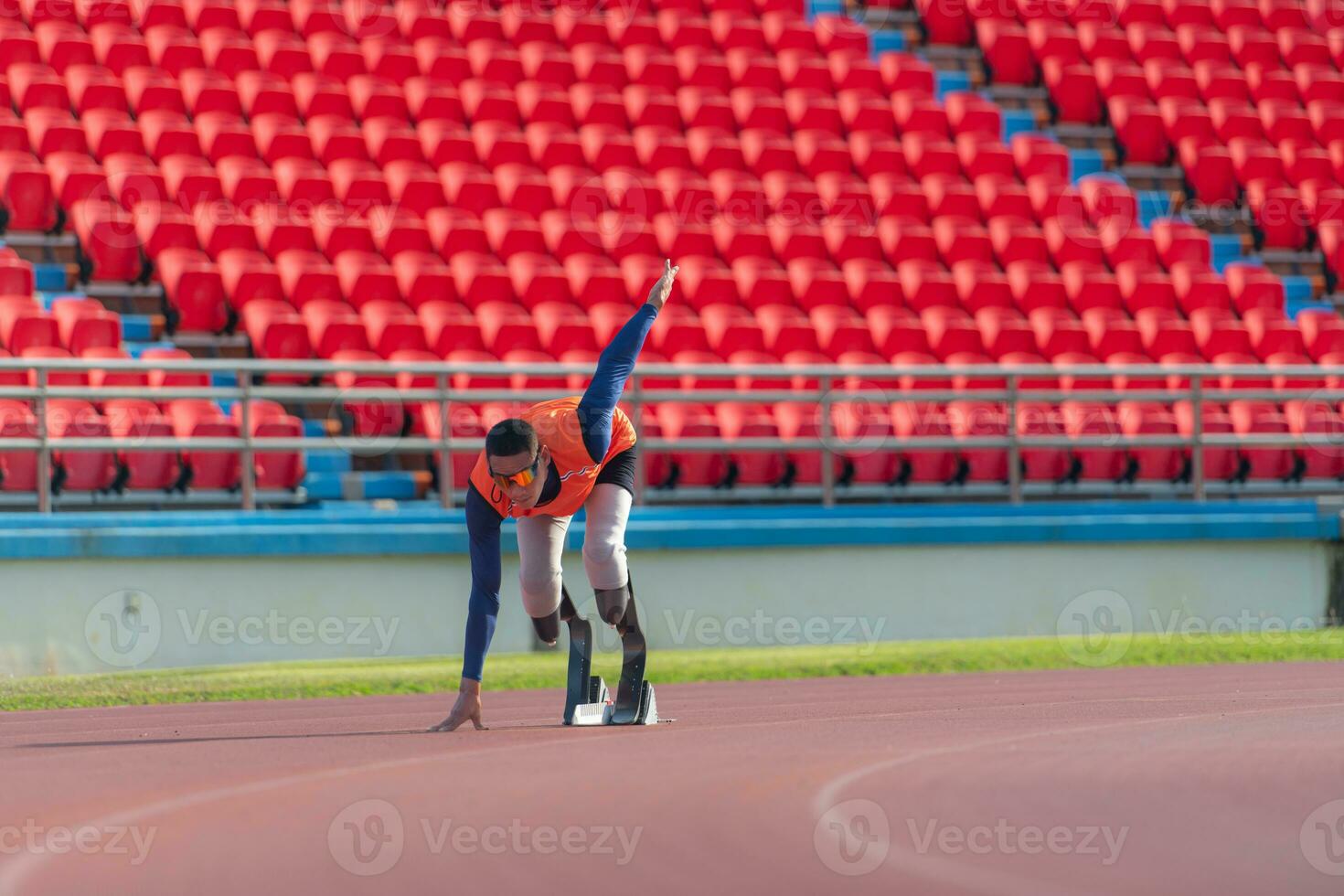 Disabled athletes prepare in starting position ready to run on stadium track photo