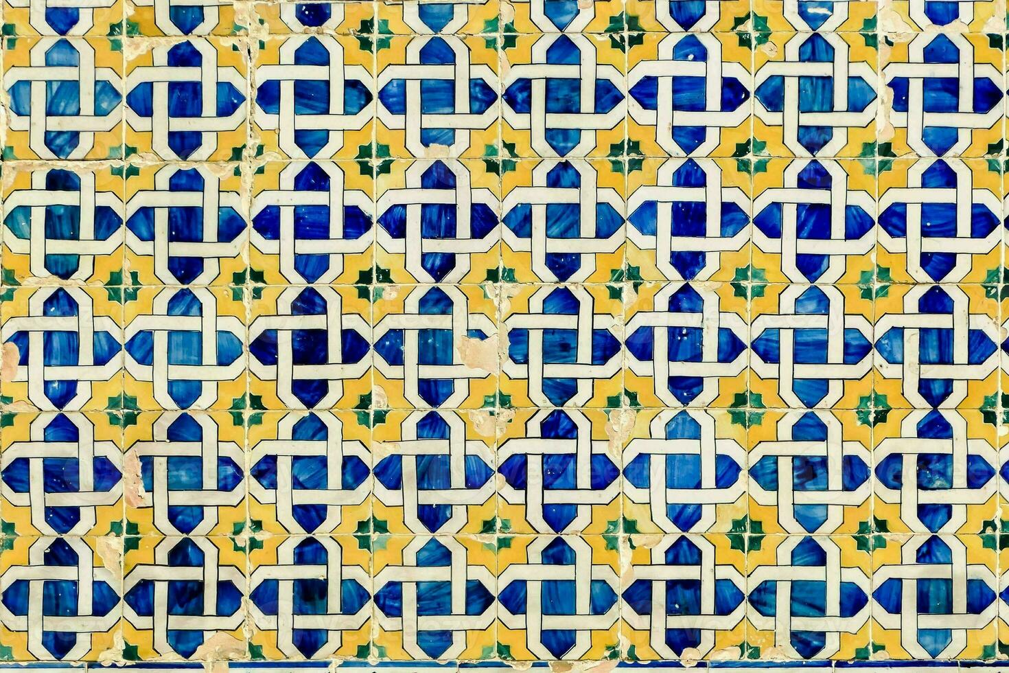 a blue and yellow tile with a pattern photo