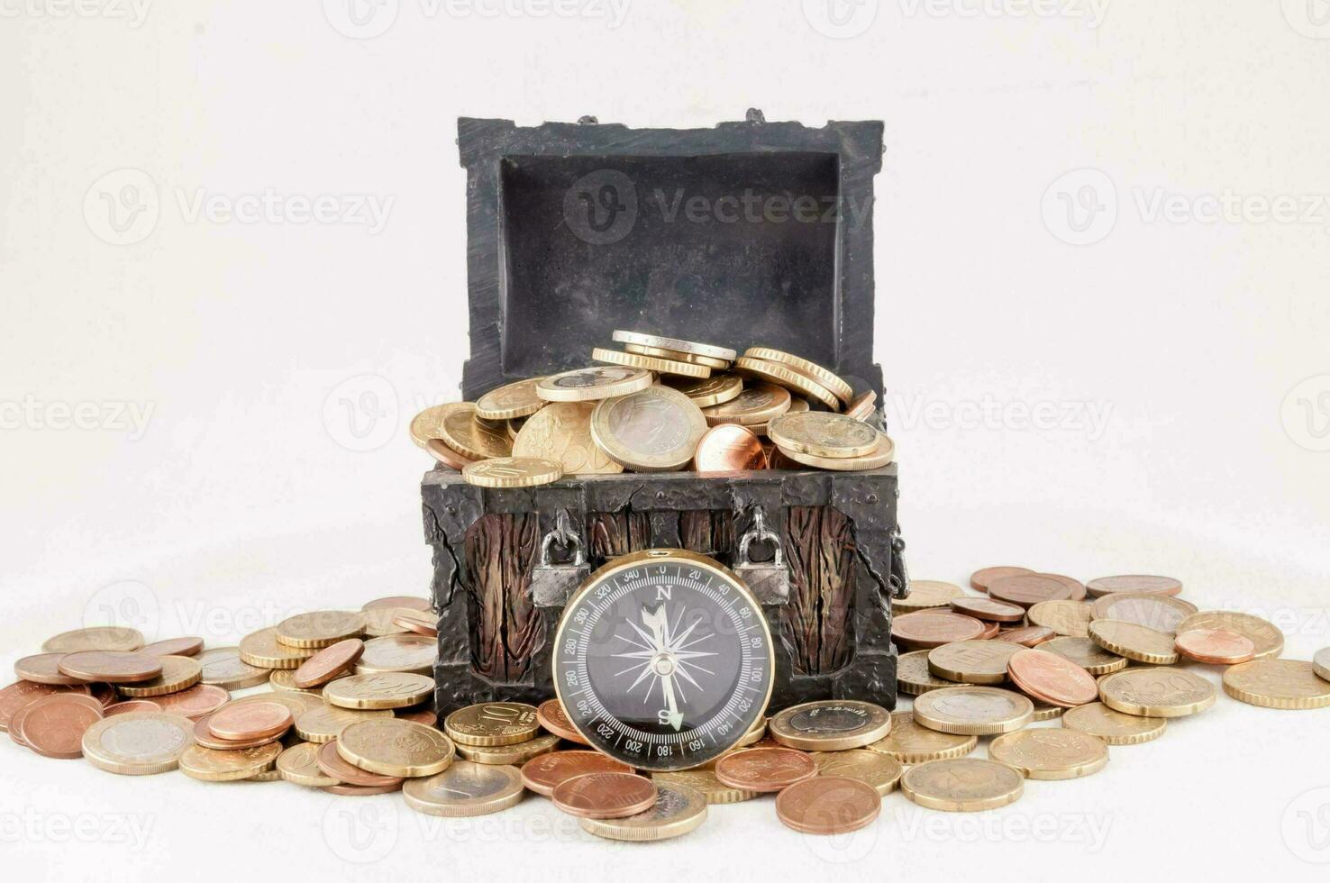 a chest full of coins and a compass photo