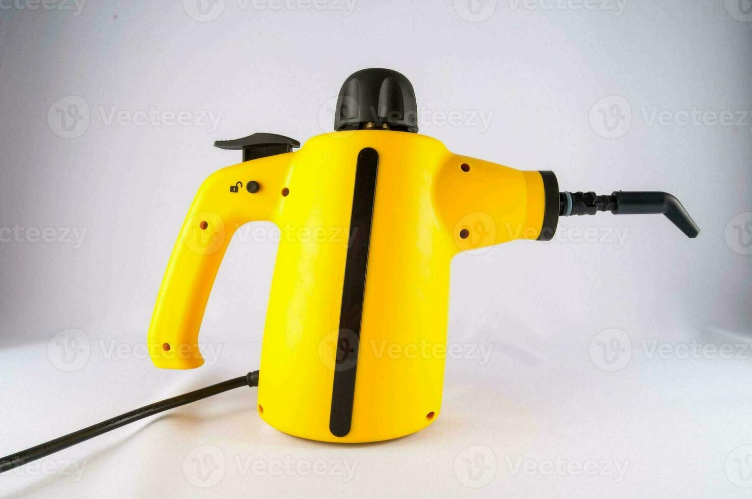 a yellow electric hand held spray gun photo