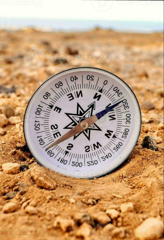 a compass on the beach photo