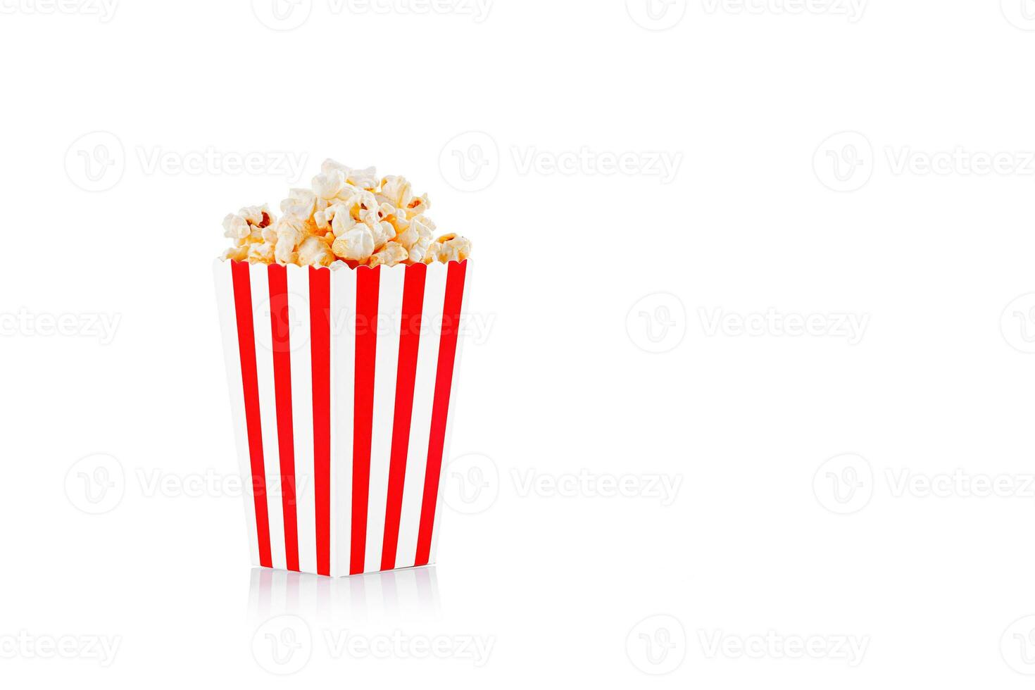 Glass with popcorn on a white background photo