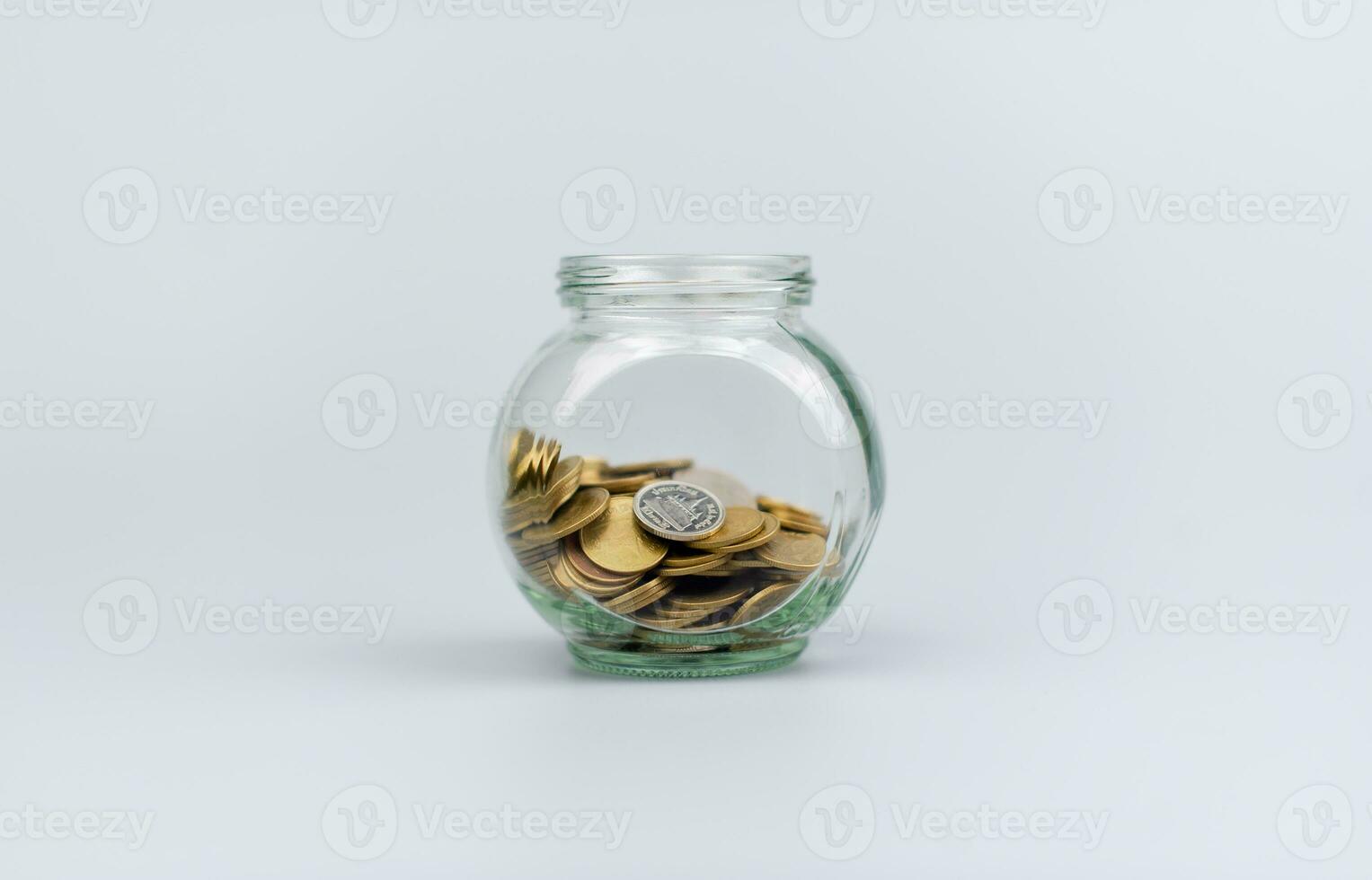 Saving coins in a glass jar Finance and financial investment, cash flow, income, wages, Thai baht photo