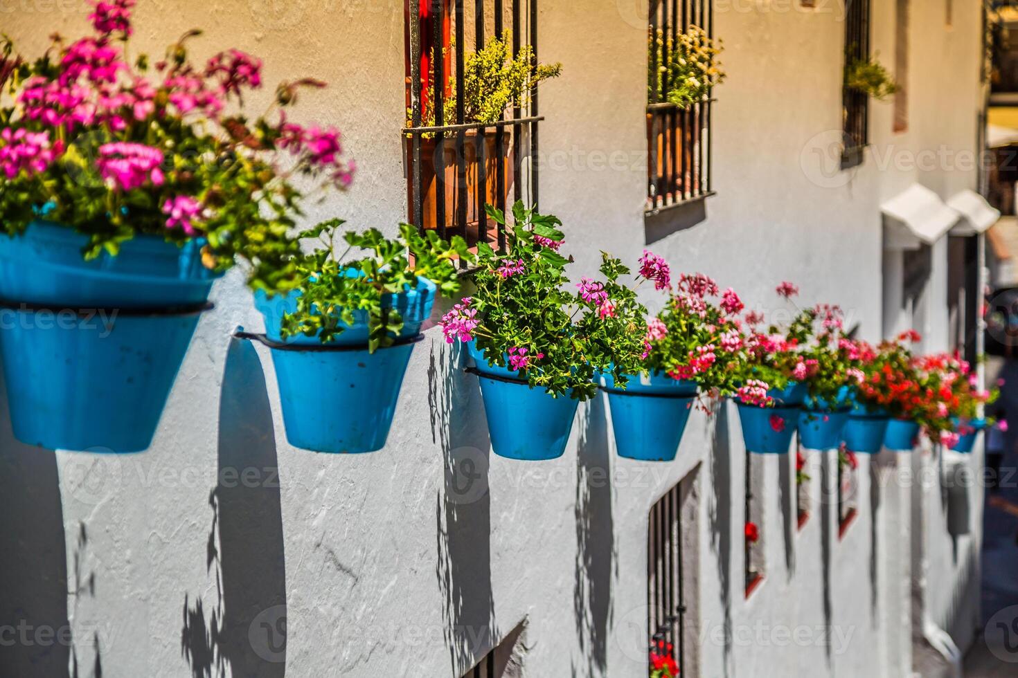 Street with flowers in the Mijas town, Spain photo