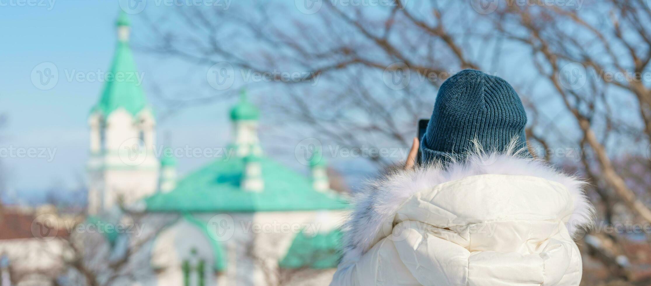 Woman tourist Visiting in Hakodate, Traveler in Sweater sightseeing Russian Orthodox Church with Snow in winter. landmark and popular for attractions in Hokkaido, Japan. Travel and Vacation concept photo