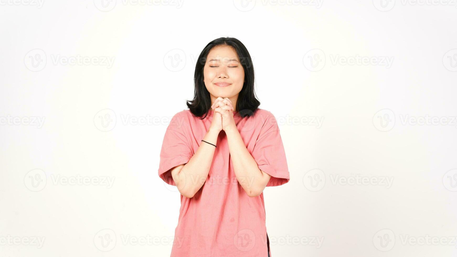 Closed eyes and holding hand for pray Of Beautiful Asian Woman Isolated On White Background photo