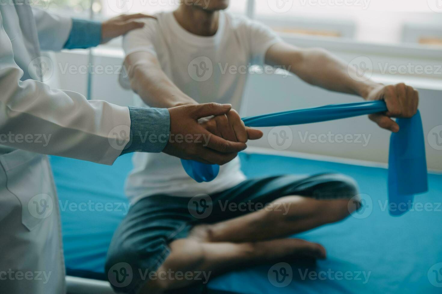 Doctor or physical therapist examines back pain and spinal area to give advice within the rehabilitation center. photo