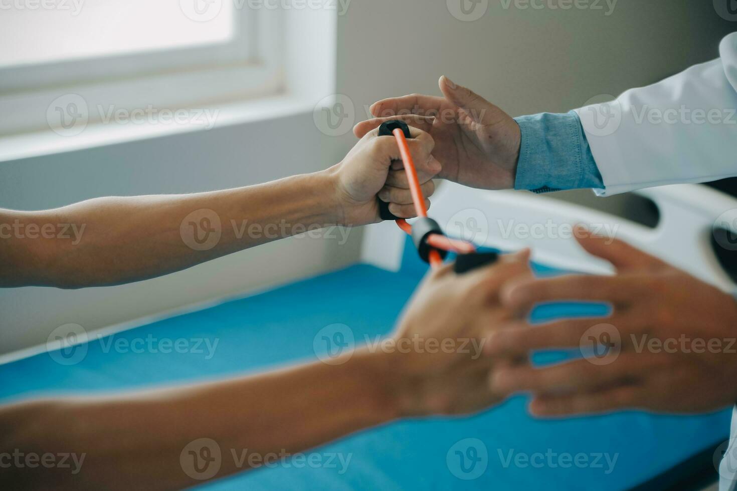 Doctor or physical therapist examines back pain and spinal area to give advice within the rehabilitation center. photo