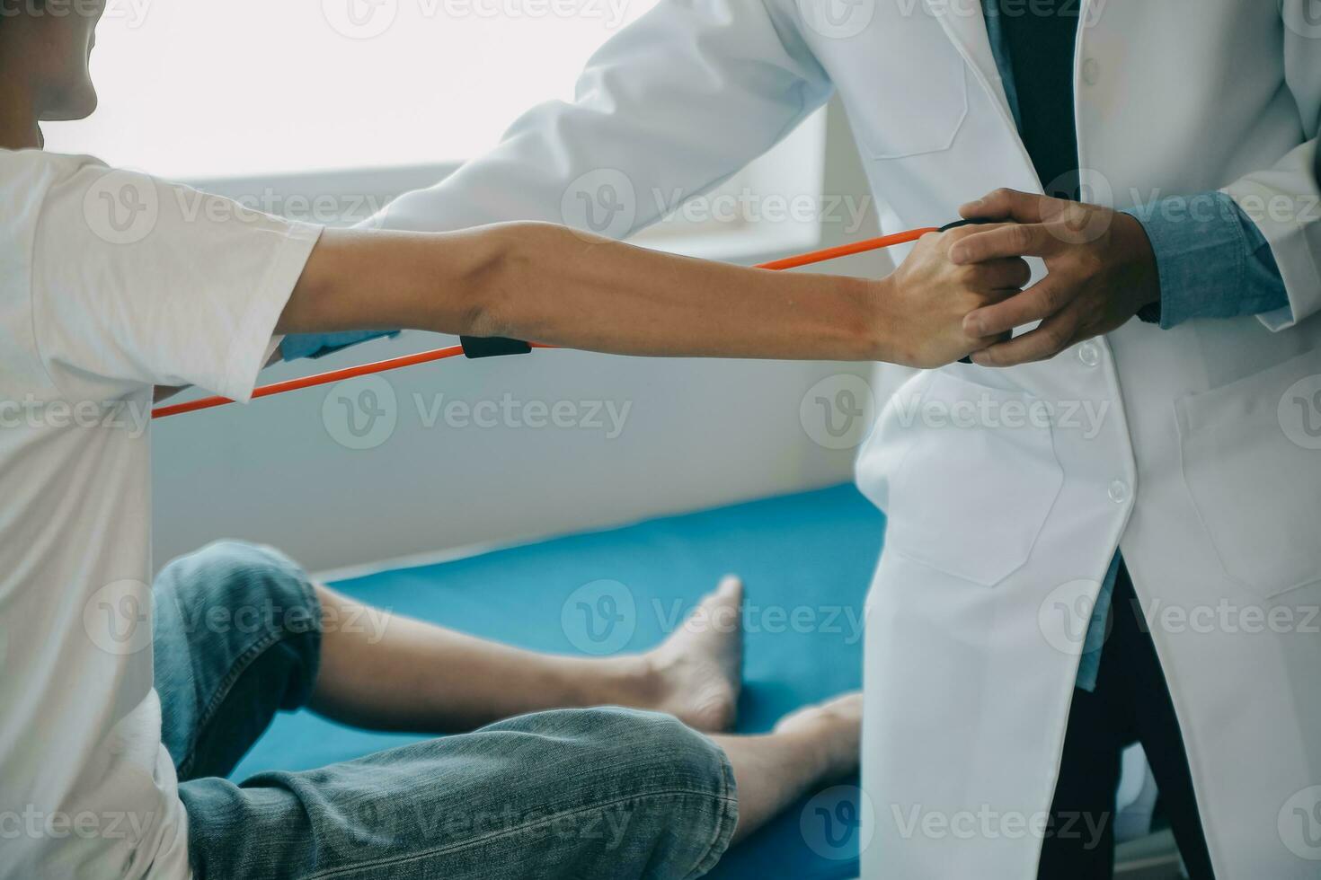 Doctor or physical therapist examines back pain and spinal area to give advice within the rehabilitation center. photo