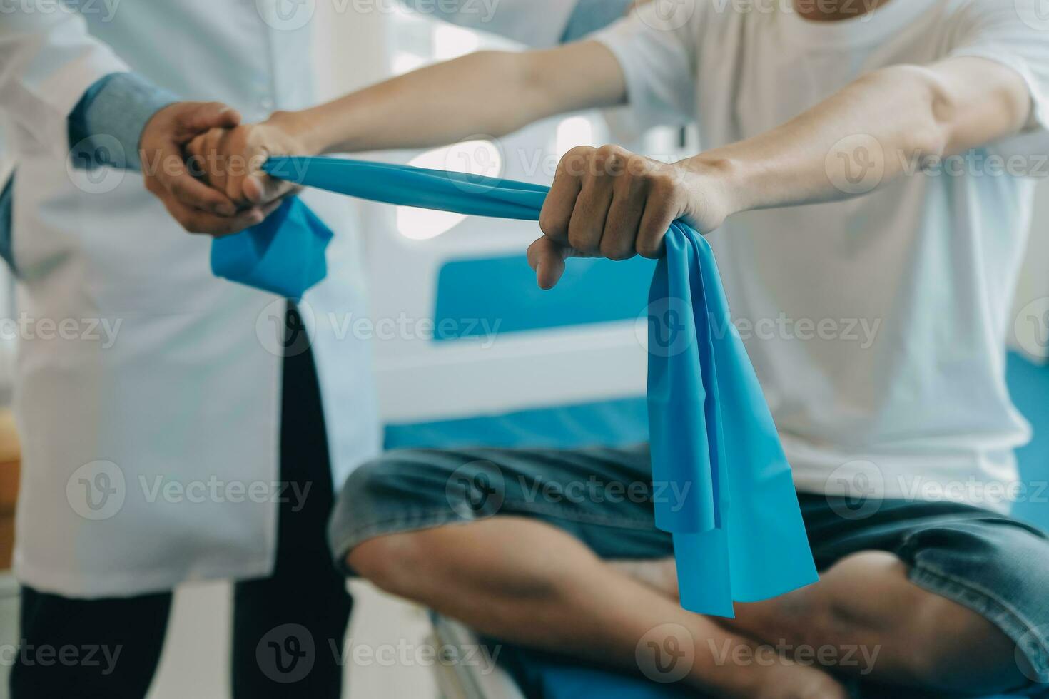 Doctor or physical therapist examines back pain and spinal area to give advice within the rehabilitation center. photo