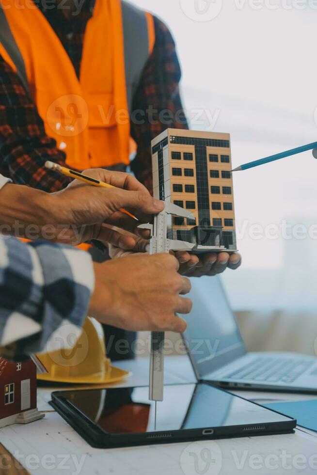 Construction and structure concept of Engineer or architect meeting for project working with partner and engineering tools on model building and blueprint in working site, contract for both companies. photo