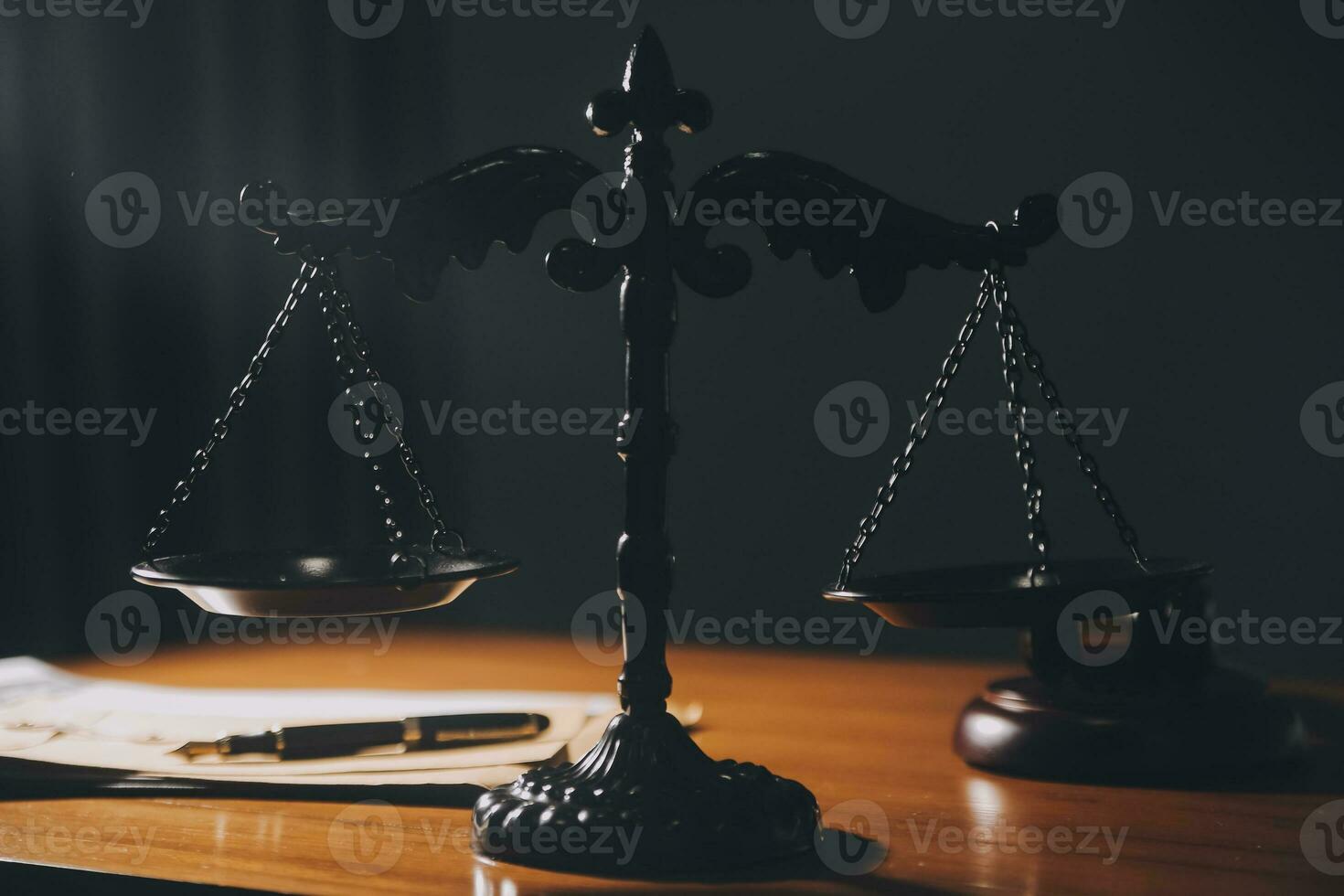Business and lawyers discussing contract papers with brass scale on desk in office. Law, legal services, advice, justice and law concept picture with film grain effect photo