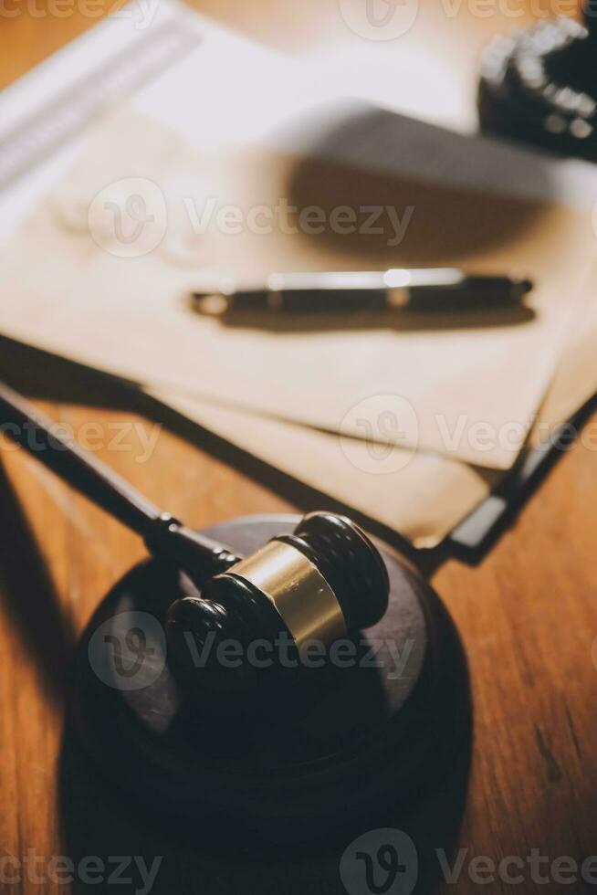 Business and lawyers discussing contract papers with brass scale on desk in office. Law, legal services, advice, justice and law concept picture with film grain effect photo