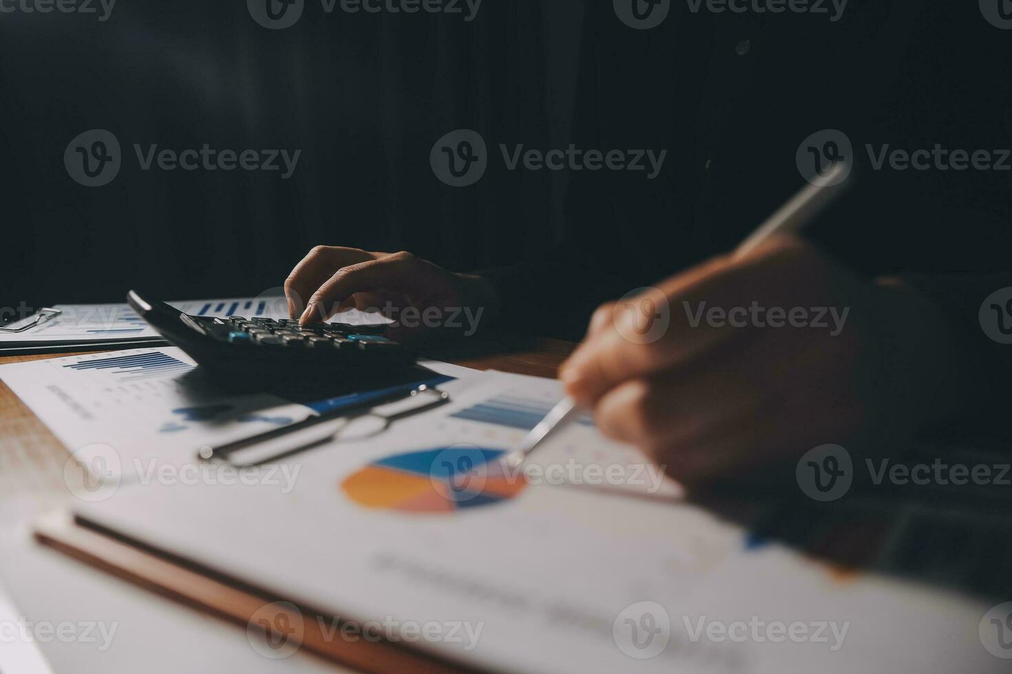 Close up businessman hand using calculator and working with laptop calculate about finance accounting at coffeeshop outdor.finance accounting concept photo