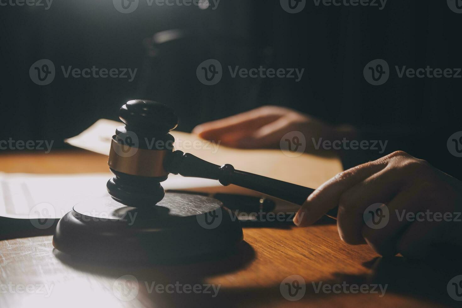 Business and lawyers discussing contract papers with brass scale on desk in office. Law, legal services, advice, justice and law concept picture with film grain effect photo