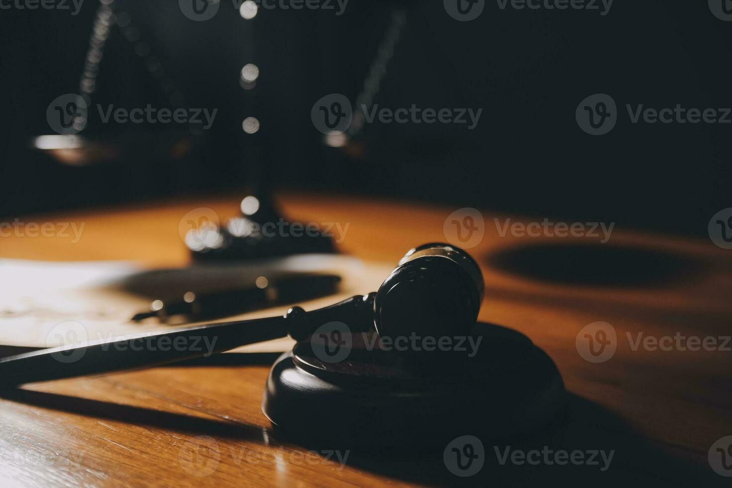 Business and lawyers discussing contract papers with brass scale on desk in office. Law, legal services, advice, justice and law concept picture with film grain effect photo