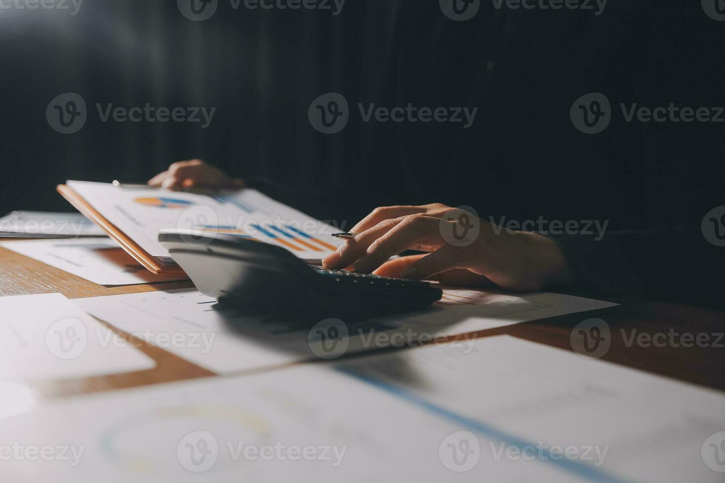 Close up businessman hand using calculator and working with laptop calculate about finance accounting at coffeeshop outdor.finance accounting concept photo