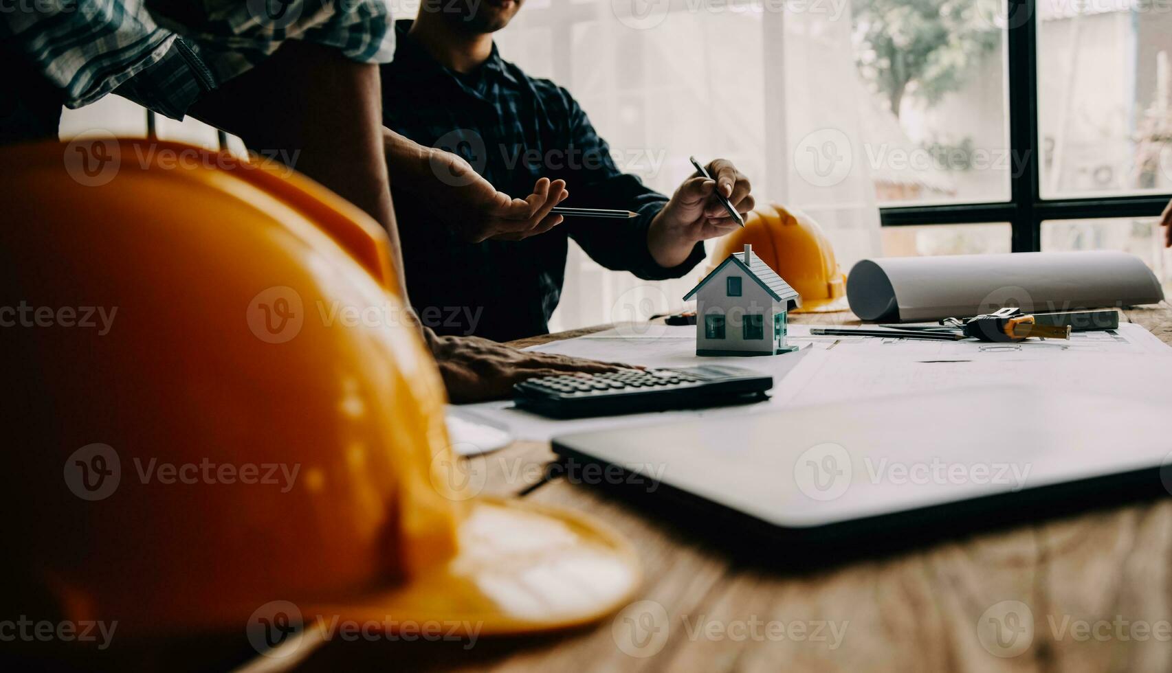 Construction and structure concept of Engineer or architect meeting for project working with partner and engineering tools on model building and blueprint in working site, contract for both companies. photo