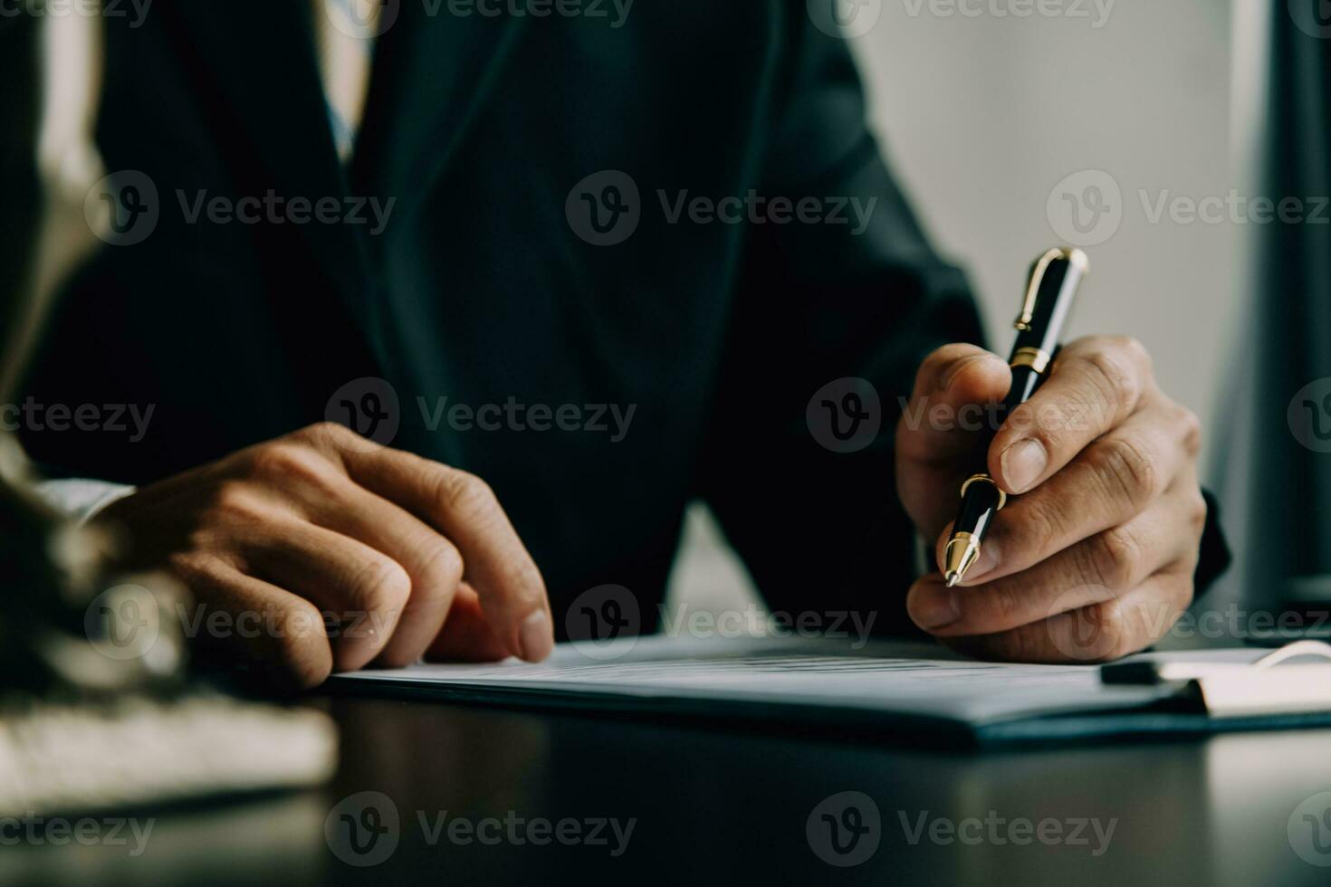 Business and lawyers discussing contract papers with brass scale on desk in office. Law, legal services, advice, justice and law concept picture with film grain effect photo