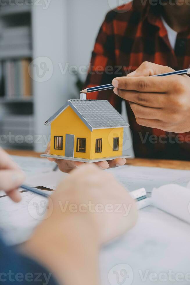 Close up of civil male engineer asian working on blueprint architectural project at construction site at desk in office. photo