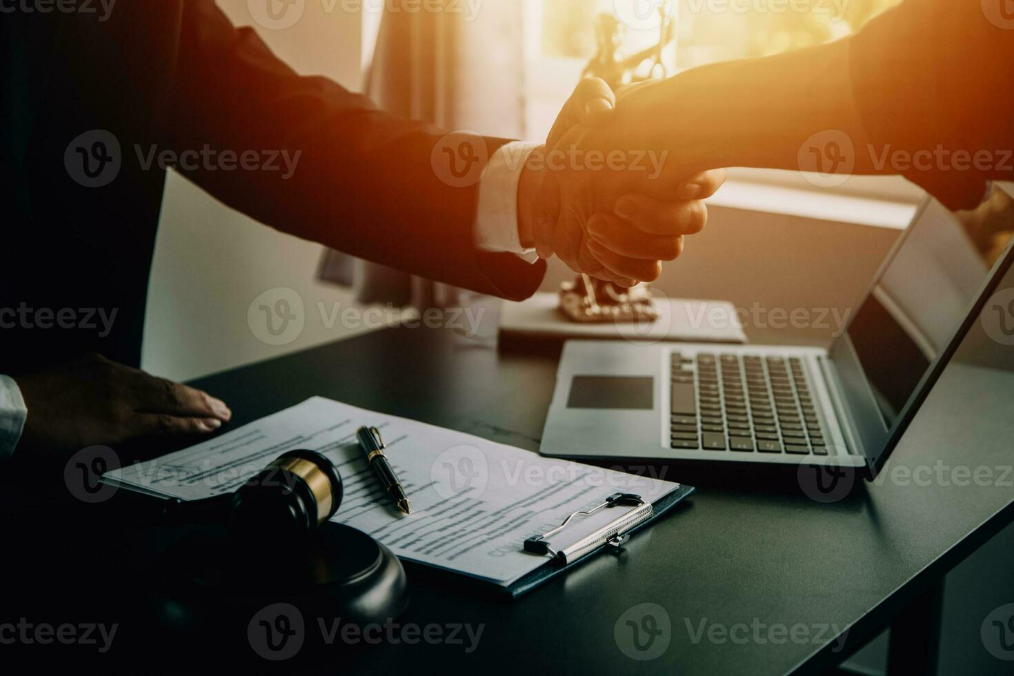 Business and lawyers discussing contract papers with brass scale on desk in office. Law, legal services, advice, justice and law concept picture with film grain effect photo